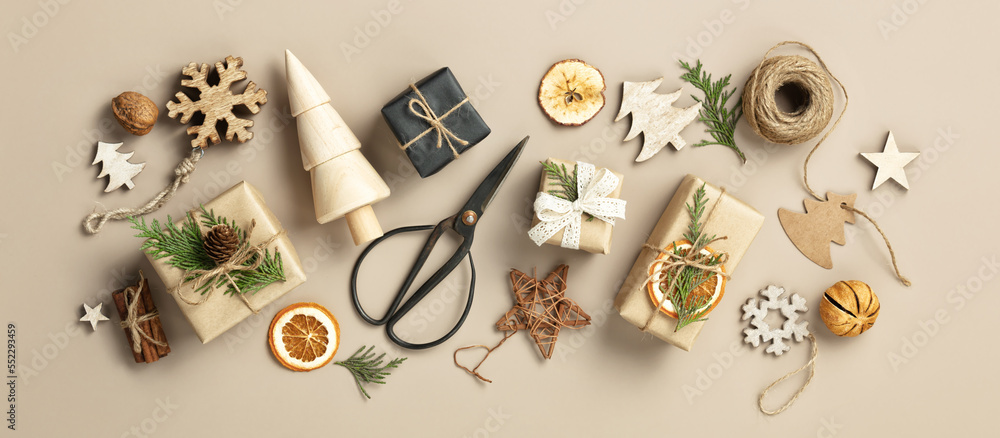 Natural color Christmas gift boxes on beige background, eco friendly trendy zero waste packaging fla