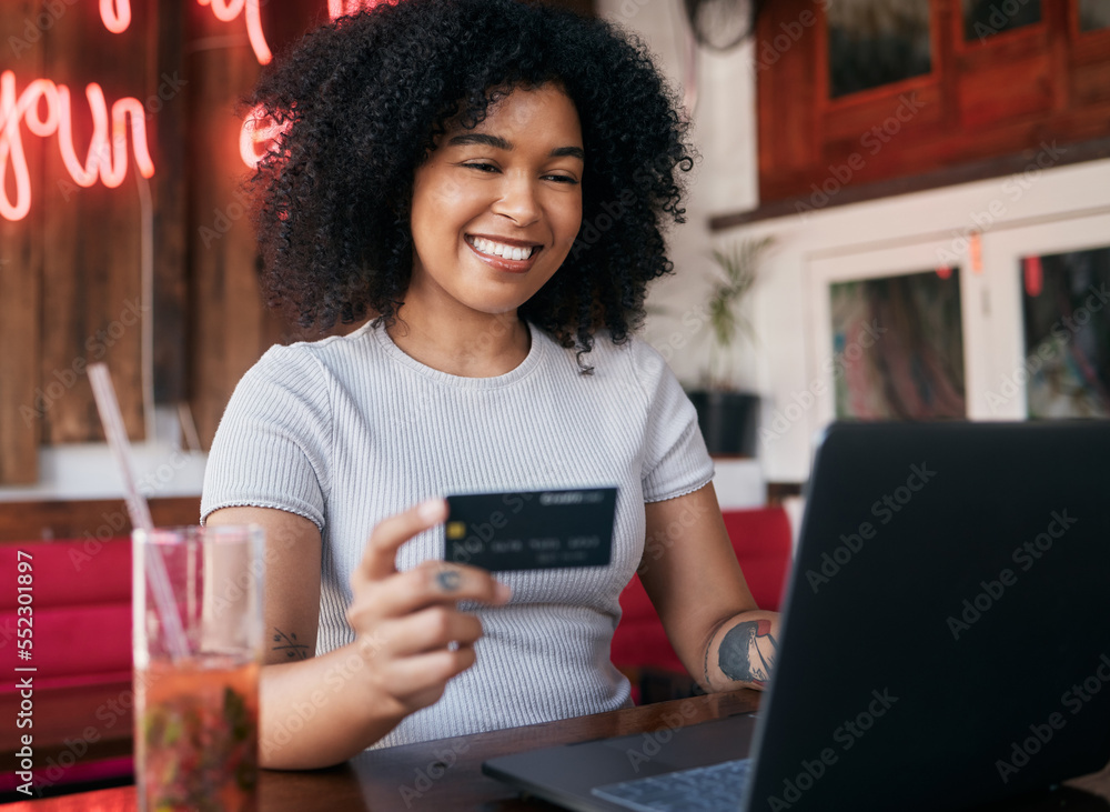 Woman, credit card and laptop in cafe, ecommerce and discount purchase. Young black woman, girl and 