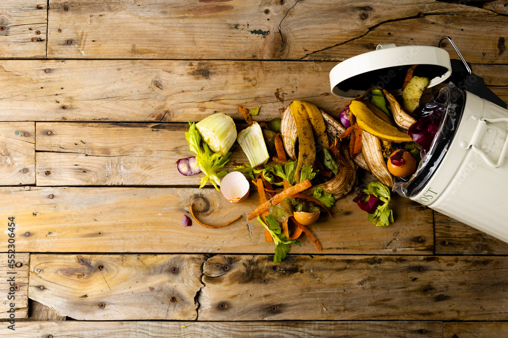 Organic fruit and vegetable food waste spilling from open kitchen composting bin