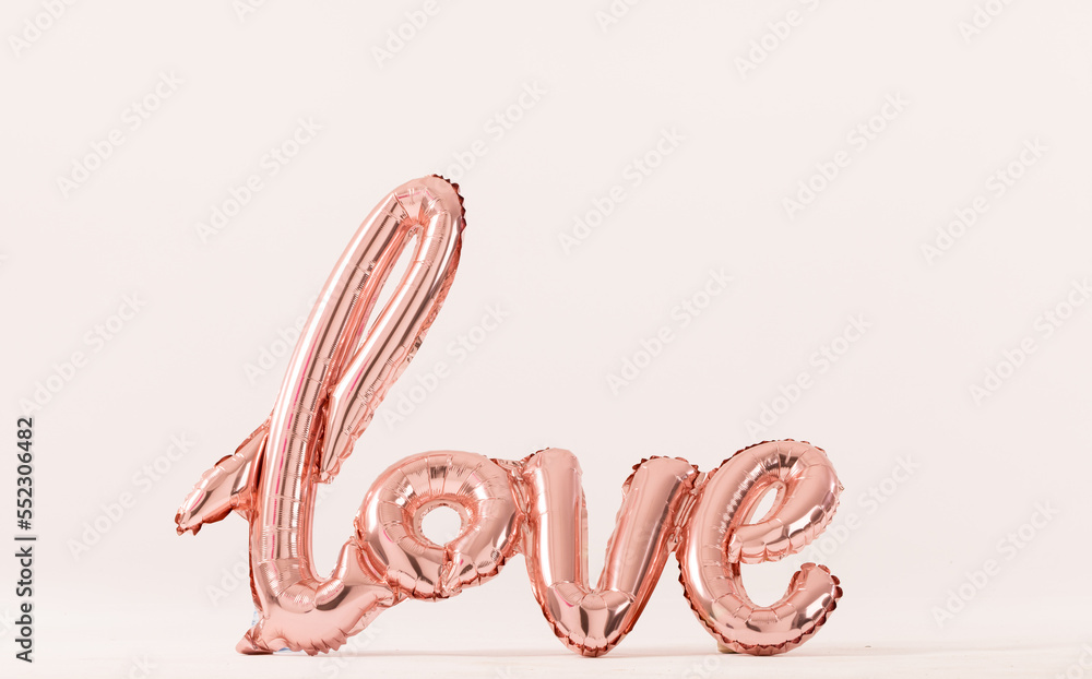 Metallic pale pink love text balloon on white background with copy space