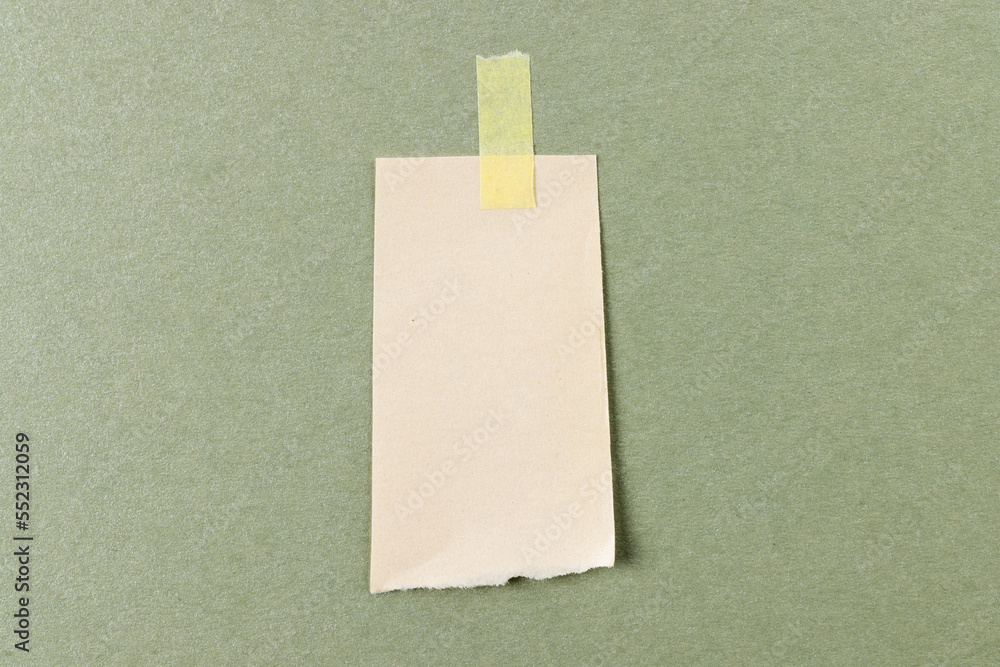 Ripped up piece of white paper with copy space on cardboard background