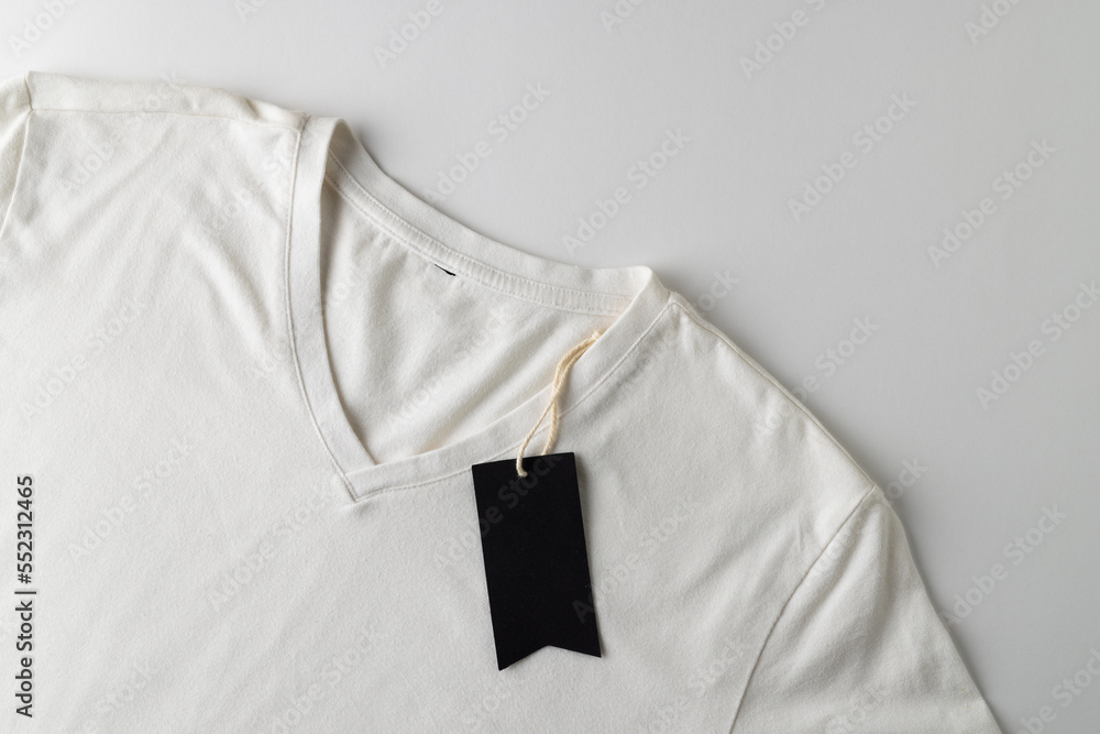 White t shirt with black tag with copy space on white background