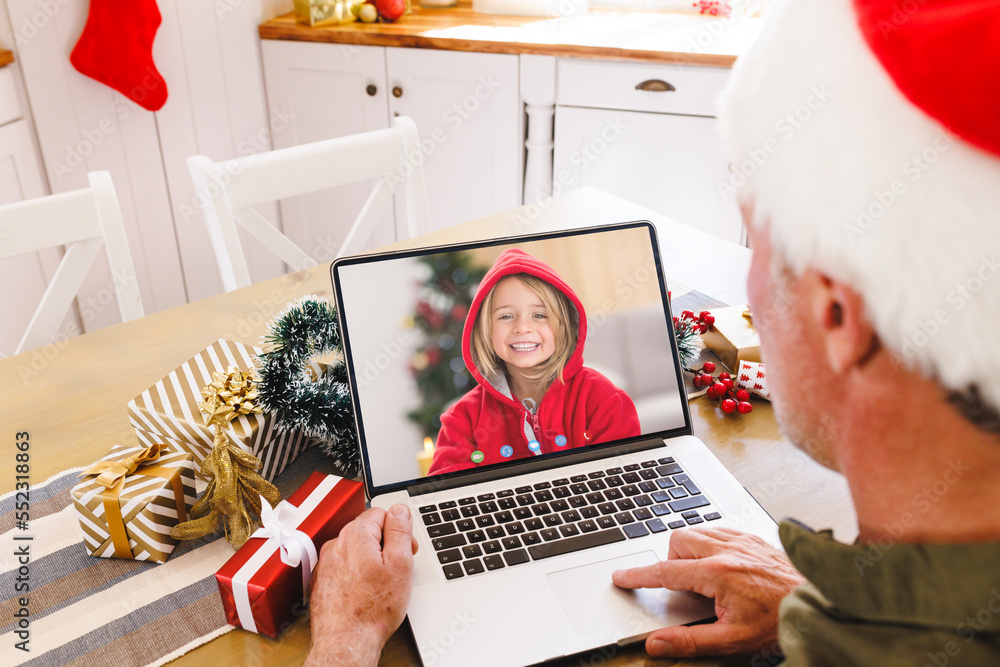 Senior caucasian man having christmas video call with caucasian girl