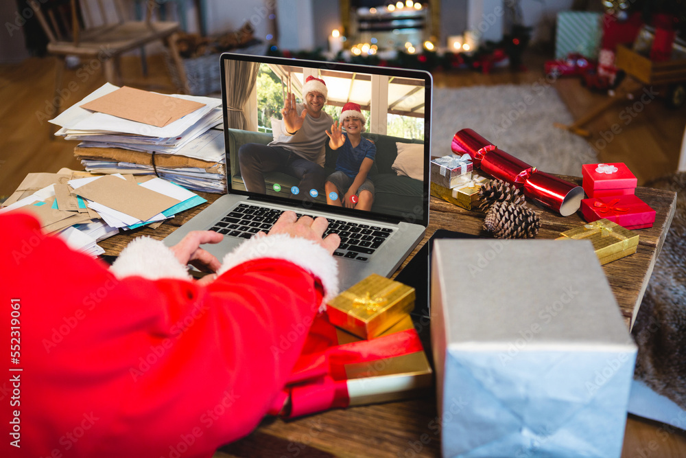 Senior caucasian man having christmas video call with caucasian man and his son