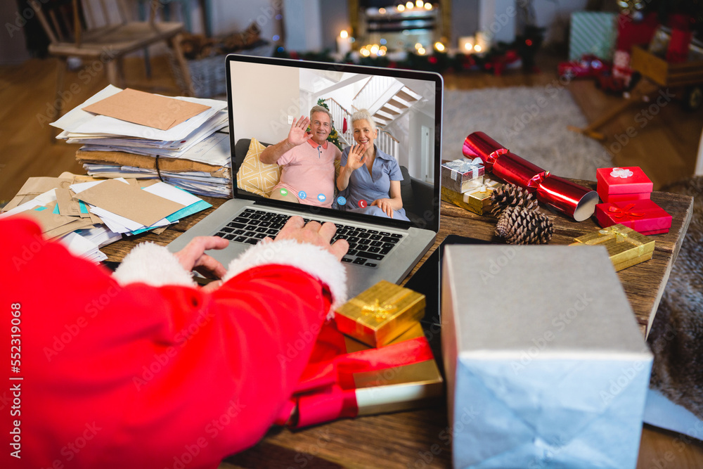 Senior caucasian man having christmas video call with senior caucasian couple