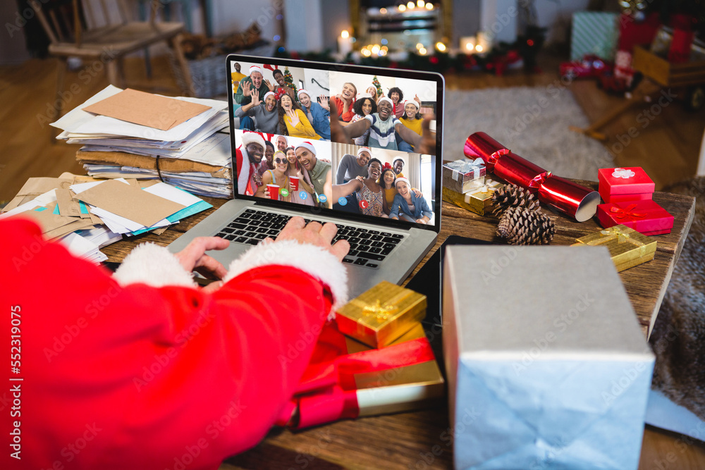 Senior caucasian man having christmas video call with diverse people