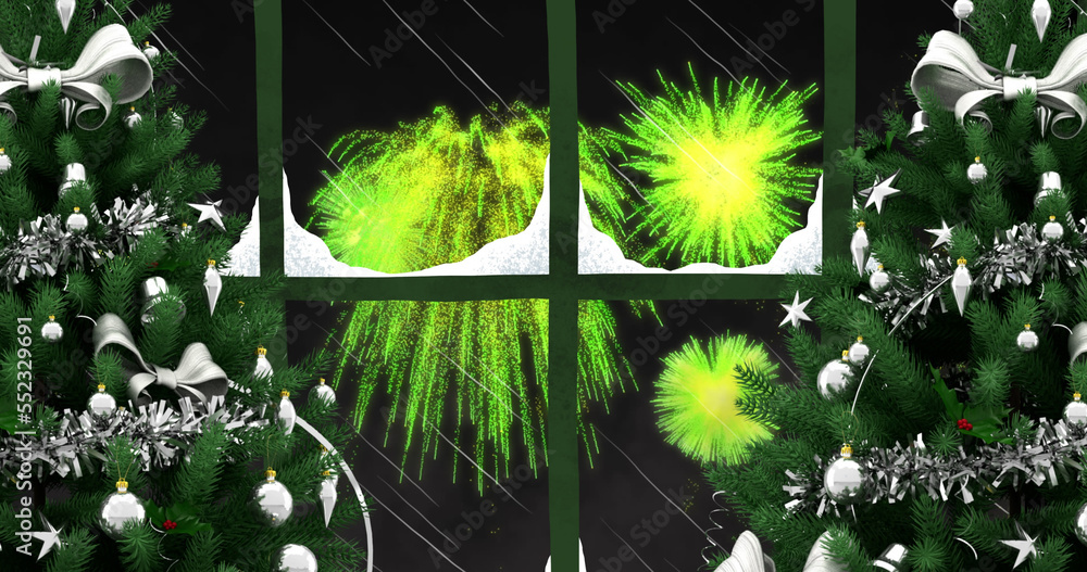 Image of window with snow, christmas trees and green fireworks exploding in night sky