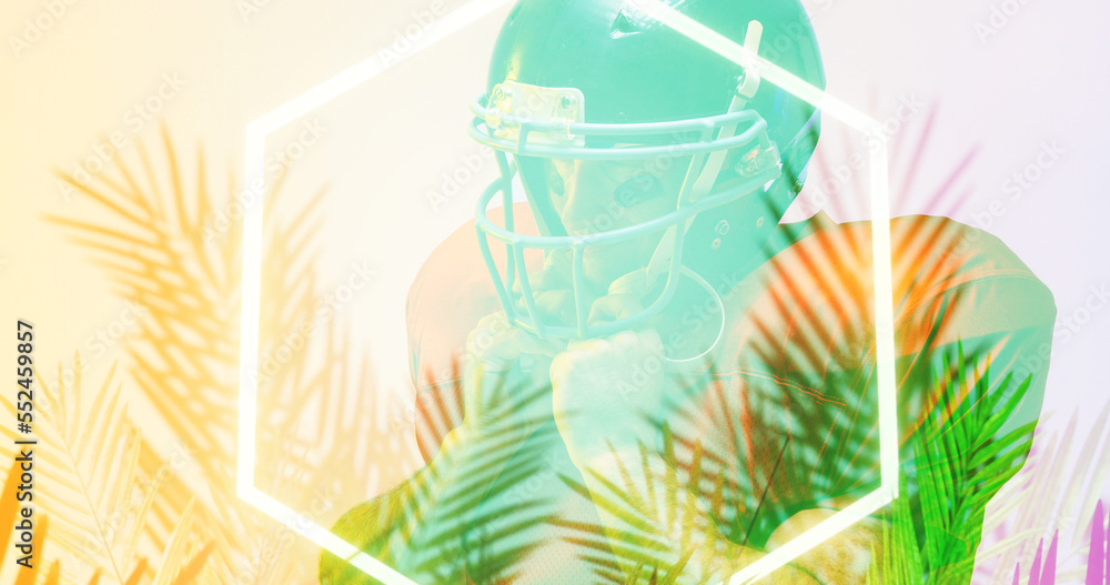 Close-up of american football player wearing helmet by glowing hexagon and plants, copy space