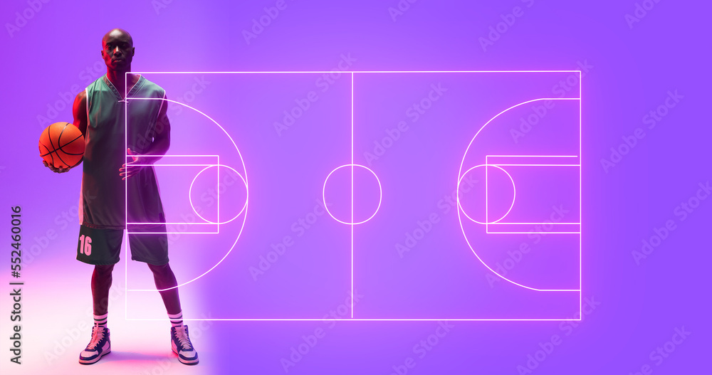 Composite of bald african american player with ball standing by illuminated basketball court