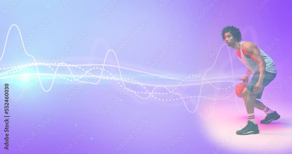 Composite of biracial basketball player dribbling ball with illuminated wave pattern, copy space