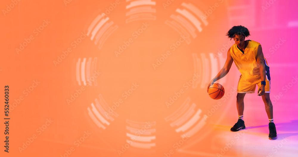 Composite of biracial basketball player dribbling ball by floral pattern, copy space