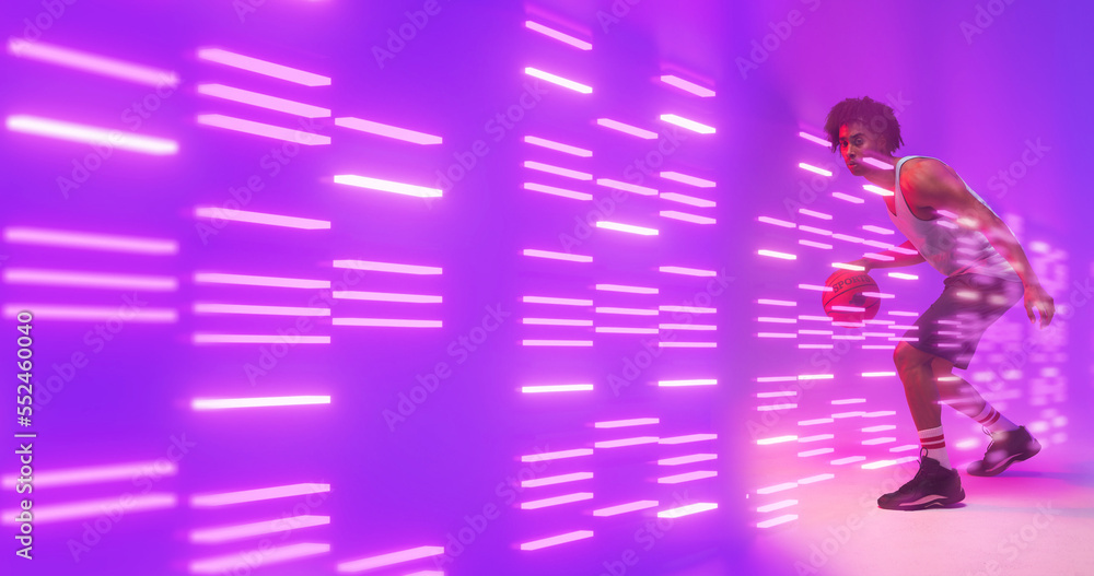 Composite of biracial basketball player dribbling by illuminated lights over purple background