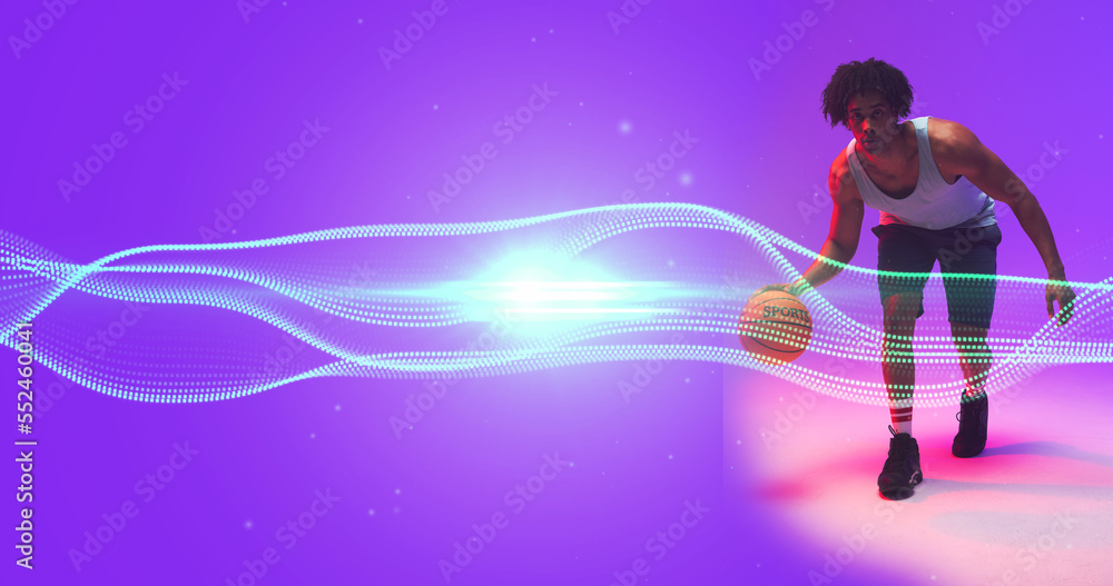 Composite of biracial basketball player dribbling ball by wave pattern and lens flare, copy space