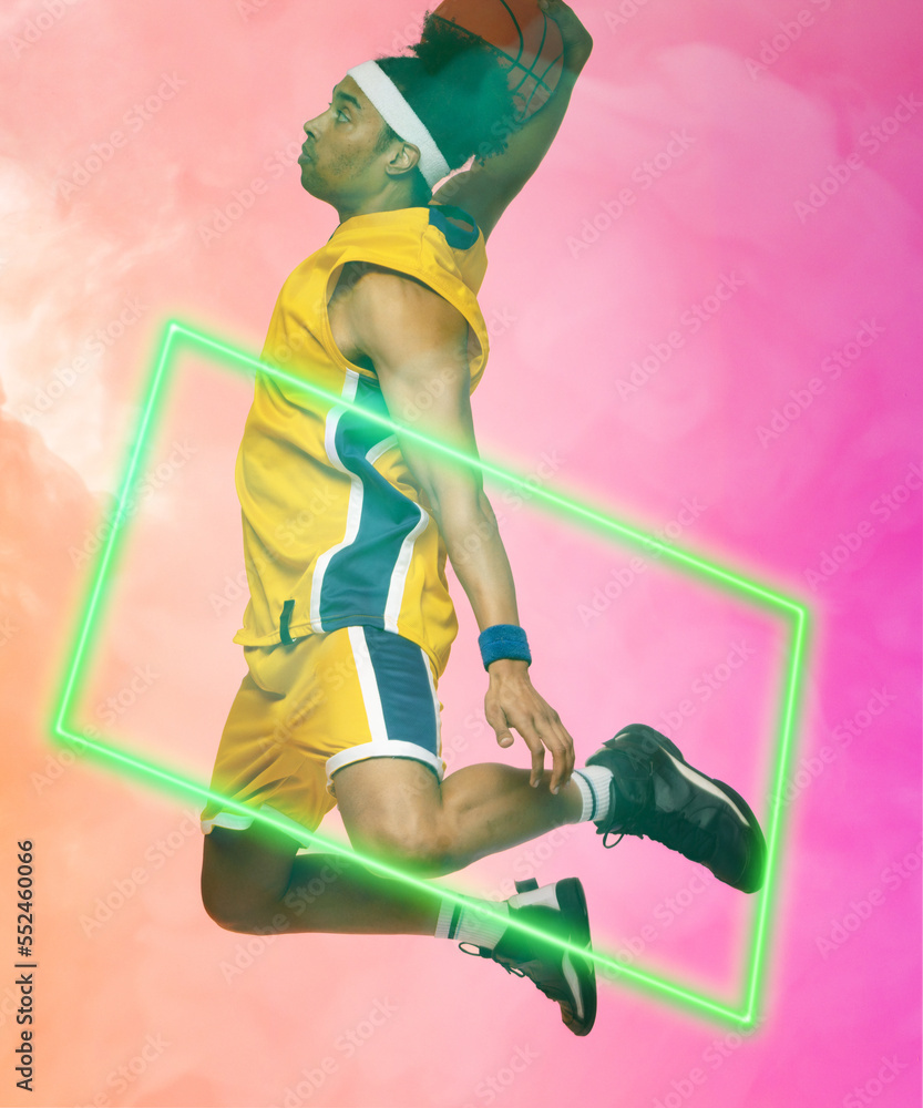 Composite of biracial male basketball player taking shot with ball by rectangle on smoky background