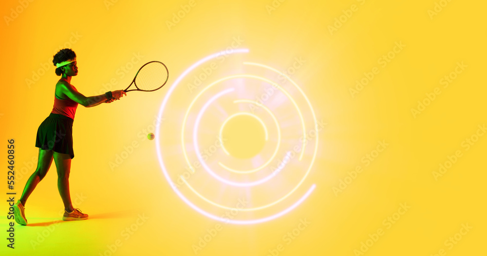 Side view of biracial female tennis player with racket by illuminated circular pattern, copy space