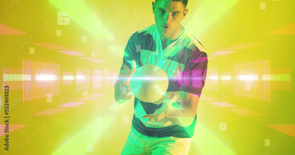 Caucasian rugby player throwing ball over illuminated rays and abstract shapes on yellow background