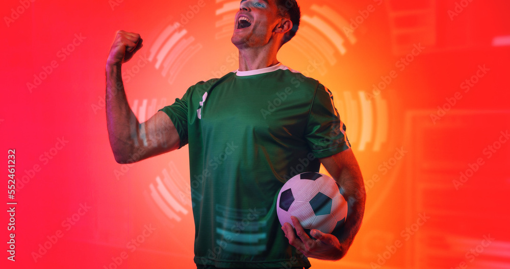 Composite of young caucasian soccer player celebrating victory with neon pattern in background