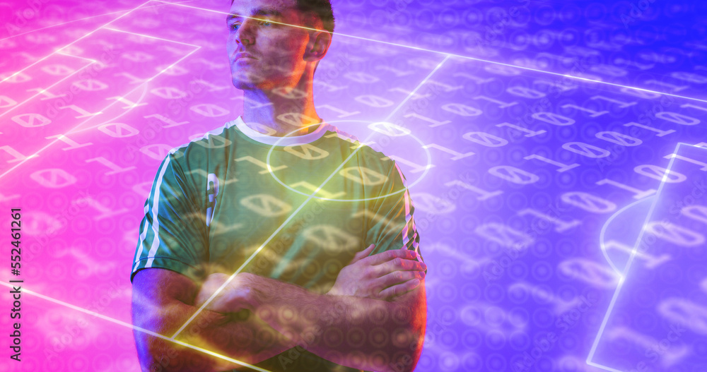 Confident caucasian player with arms crossed over neon soccer field and binary coding