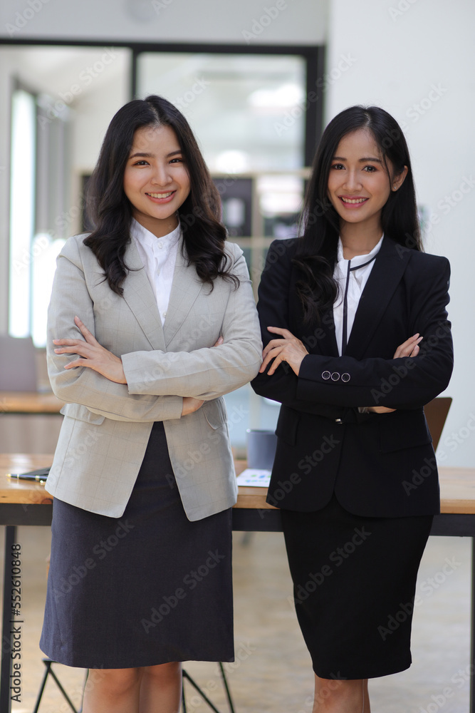 Attractive Asian businesswoman colleagues in the office.