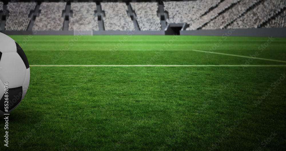 Image of close up of football on grass pitch