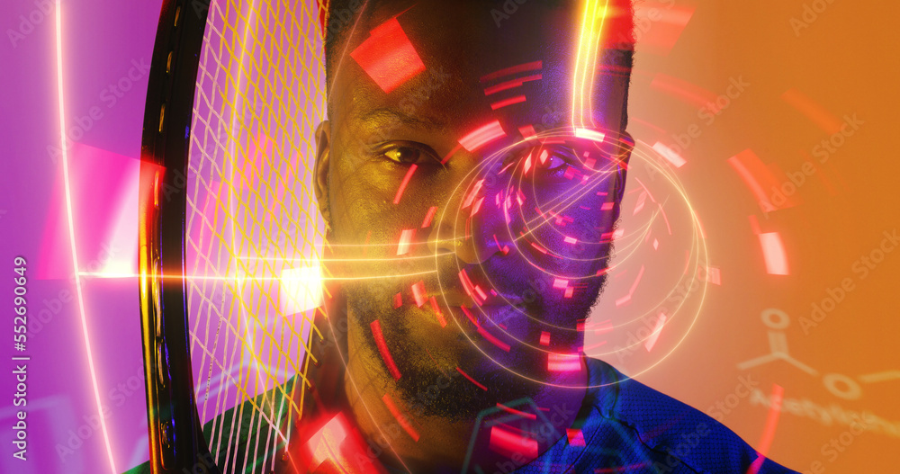 Close-up of african american tennis player holding racket over illuminated circular pattern