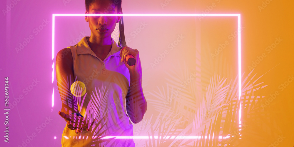 African american female tennis player holding ball and racket by illuminated rectangle and plants