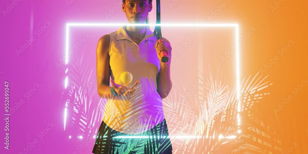 Midsection of african american tennis player with ball and racket by illuminated rectangle and plant