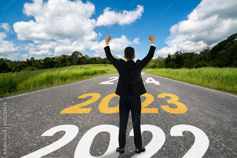 The 2023 New Year journey and future vision concept . Businessman traveling on highway road leading 