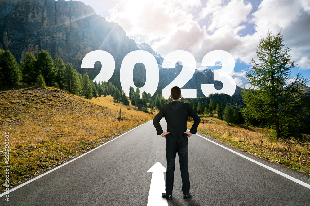 The 2023 New Year journey and future vision concept . Businessman traveling on highway road leading 