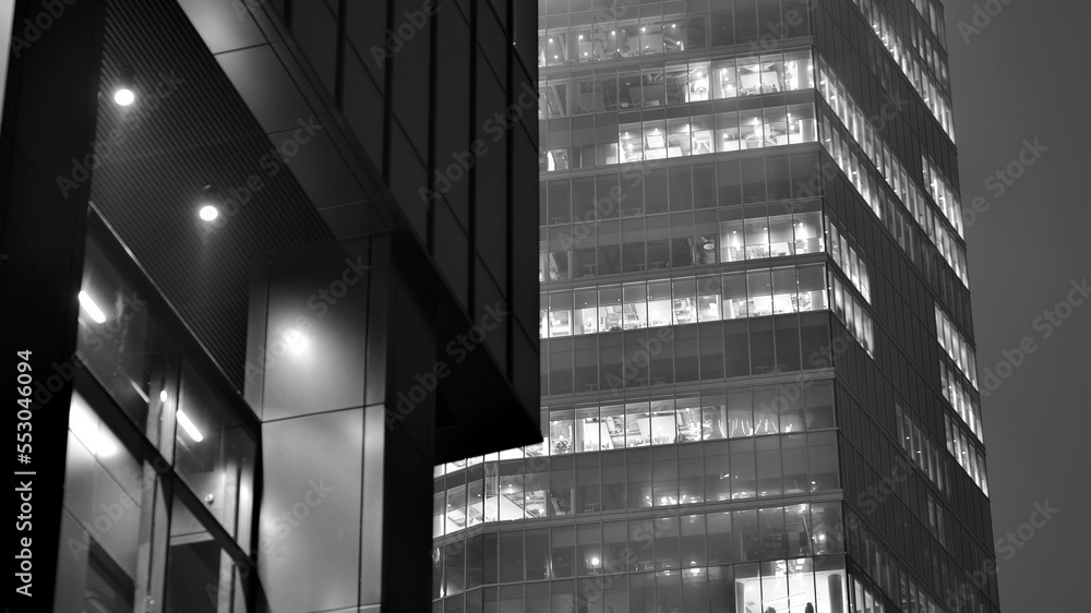 Pattern of office buildings windows illuminated at night. Glass architecture ,corporate building at 