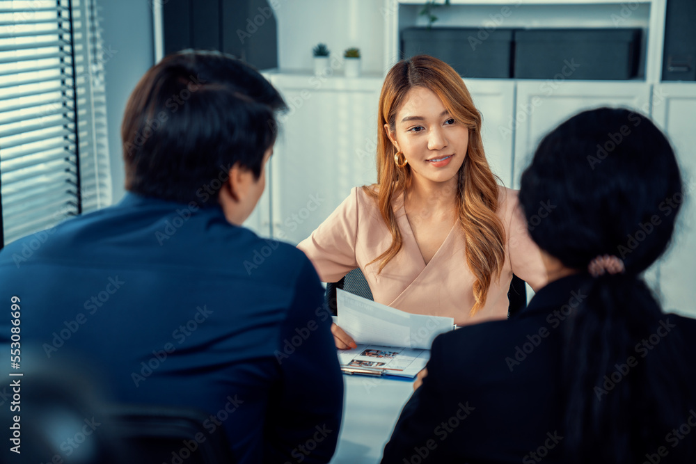 A young female asian candidate tries to impress her interviewer by being competent. International co