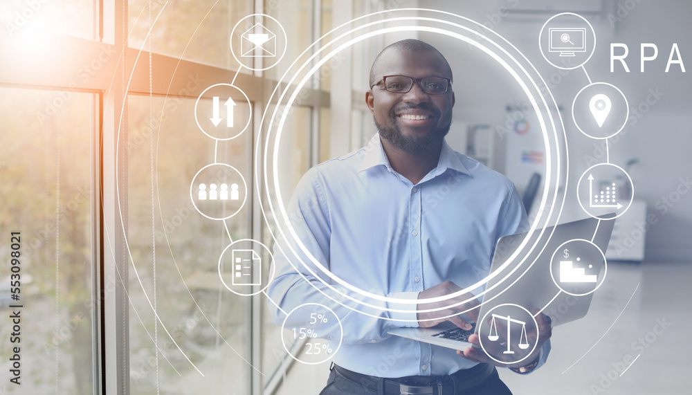 African-American businessman with laptop in office. RPA concept