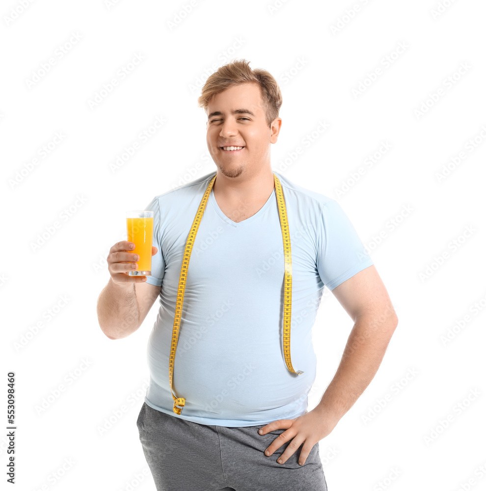 Young overweight man with measuring tape and glass of juice on white background