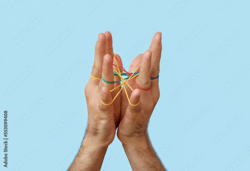 Man with rubber bands on blue background