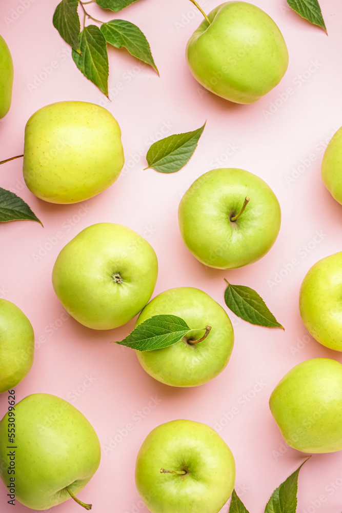 Ripe green apples on pink background