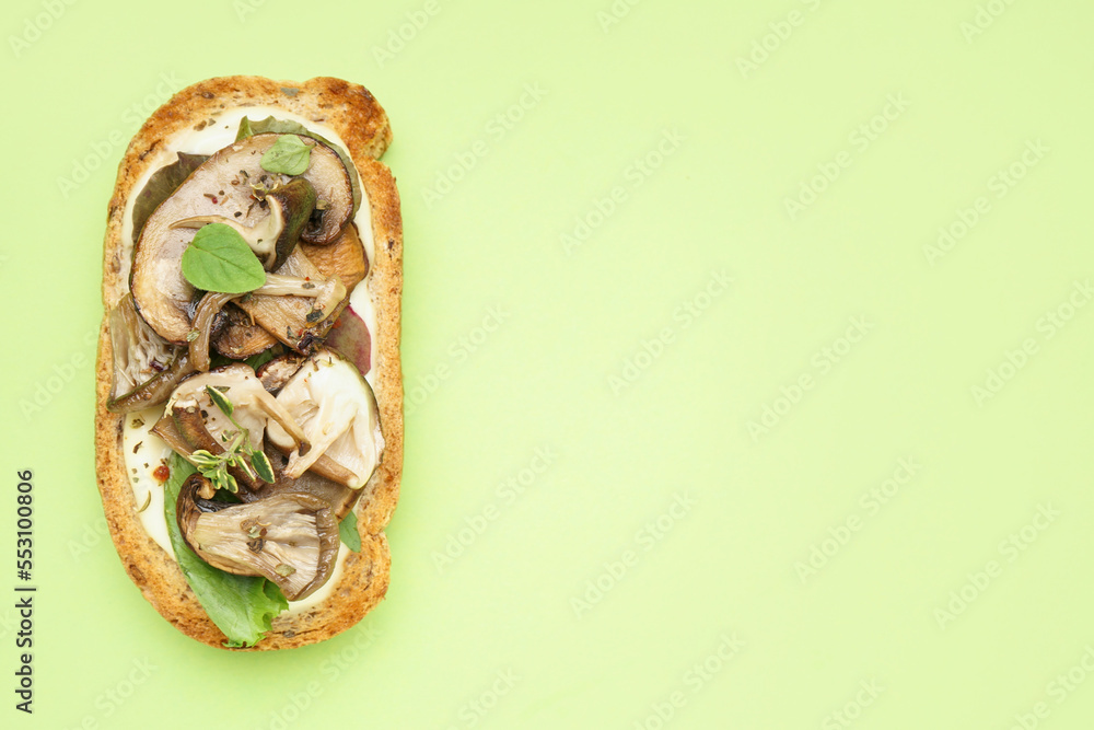 Tasty toast with cream cheese and mushrooms on green background, closeup