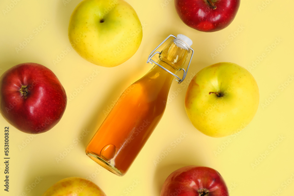 Composition with ripe apples and bottle of fresh juice on color background