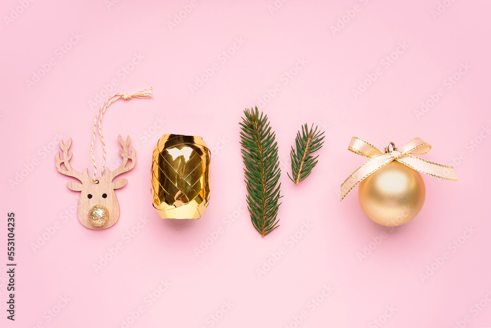 Composition with Christmas decorations, ribbon and fir branches on pink background