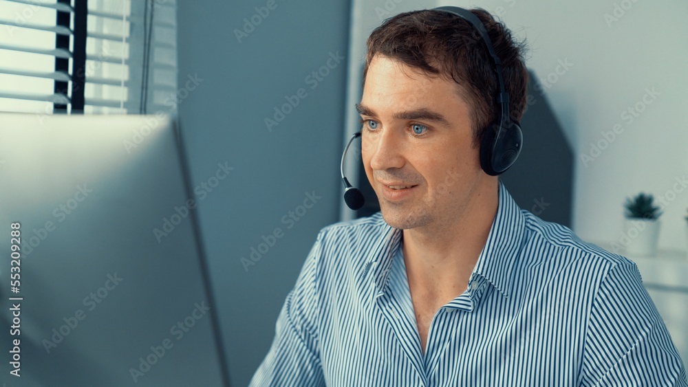 Competent male operator working with customers in the office. Concept of an operator, customer servi