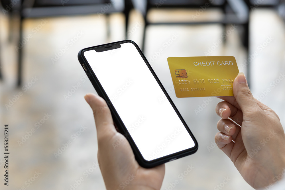 Close-up woman holding credit card using smart phone, Online shopping concept.