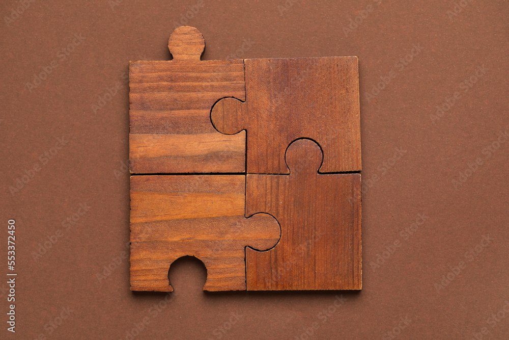 Combined pieces of puzzle on brown background