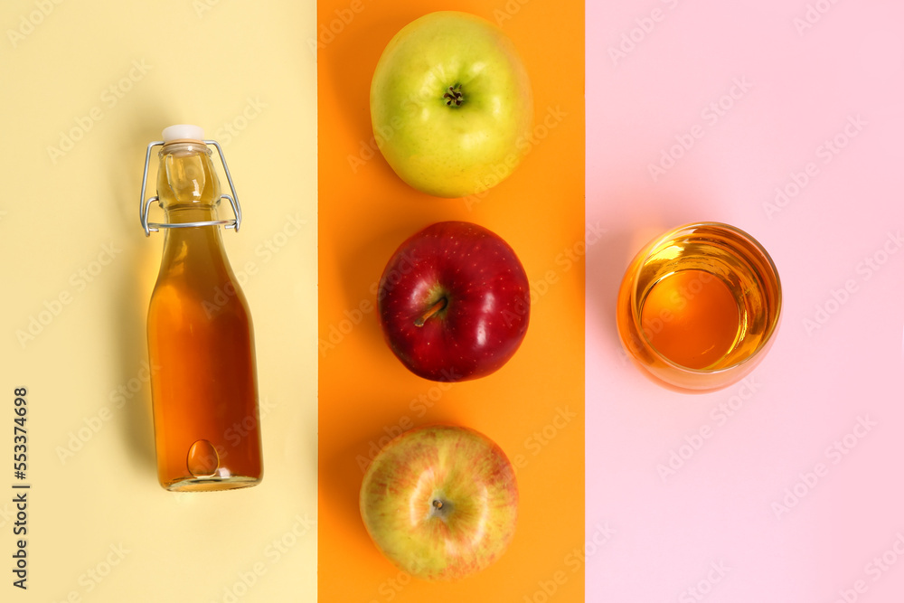 Composition with ripe apple, bottle and glass of fresh juice on color background