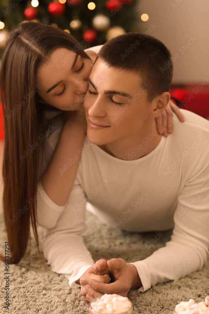 Young couple lying at home on Christmas eve, closeup