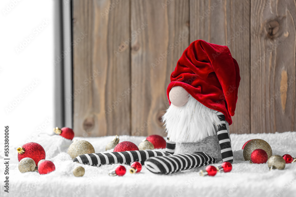 Christmas gnome and balls on table