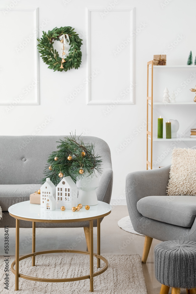 Interior of living room with house shaped candle holders and Christmas wreath