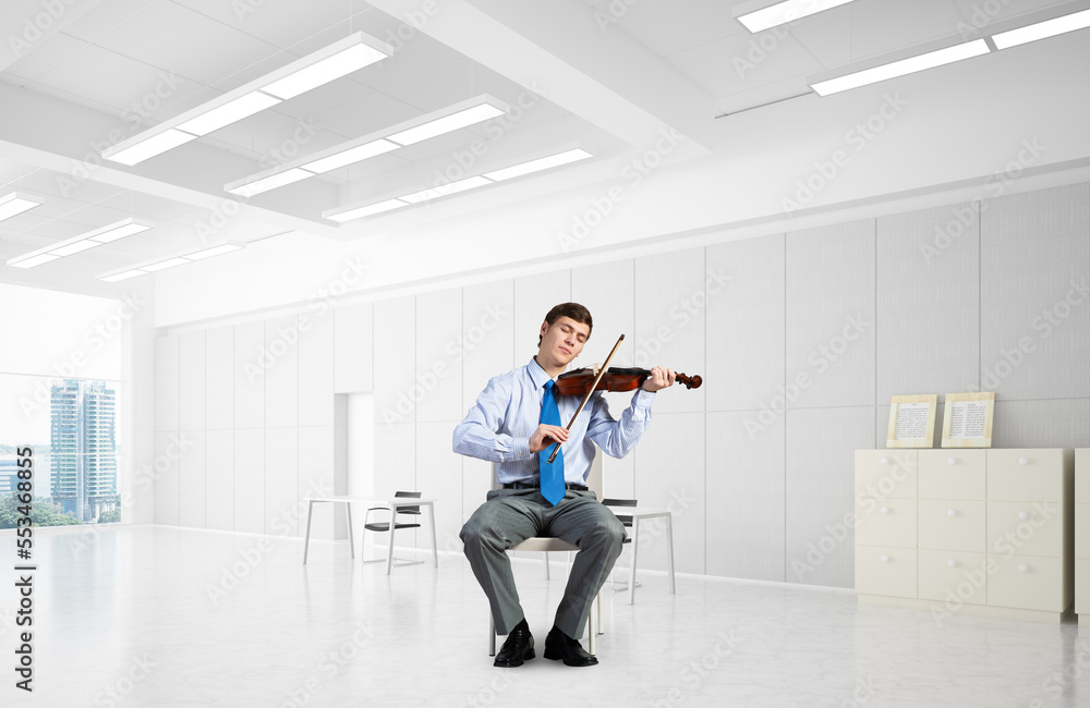 young businessman playing violin