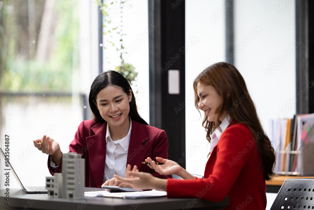 Asian businesswoman making a deal to buy a house or condo inside the office, home insurance concept