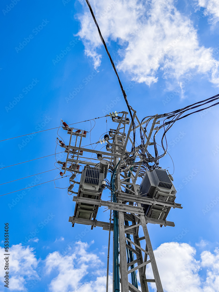 Power line of high voltage electricity trellis on sky background