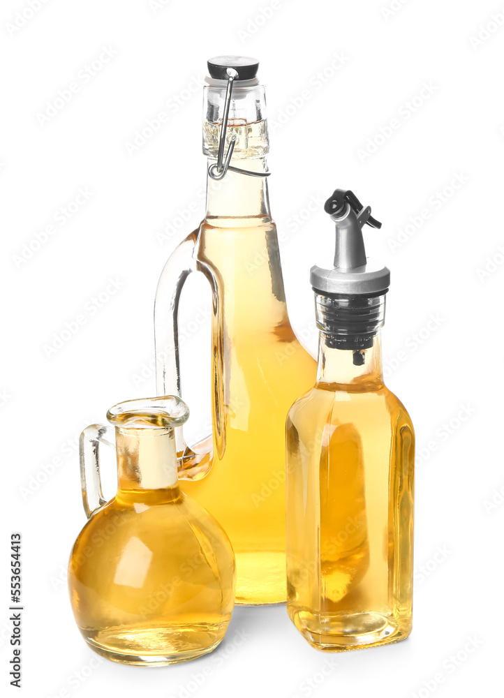 Bottles and jug of fresh apple cider vinegar isolated on white background