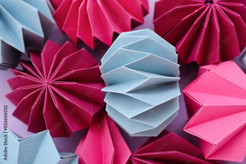 Paper Christmas balls on lilac background, closeup